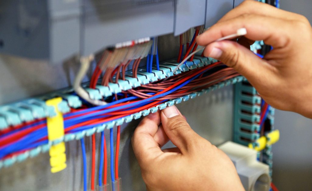 Instructor explaining ladder logic programming on SCADA